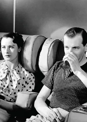 Black and white image of a couple in the 60&#039;s having a drink