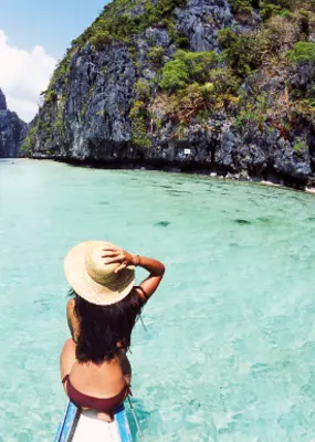 Woman swimming in the clear blue water at the Philippines 