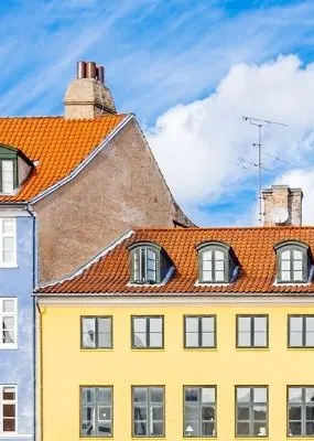 Multiple houses in different colors located in  Nyhavn Harbor