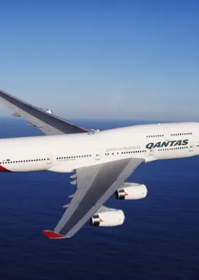 Qantas&#039; airplane soaring across the sea