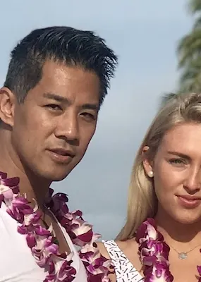 Couple at the beach with natural flower necklaces