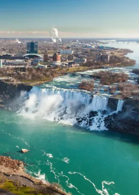 Full shot of Niagara Falls with the bridge and the city in the back