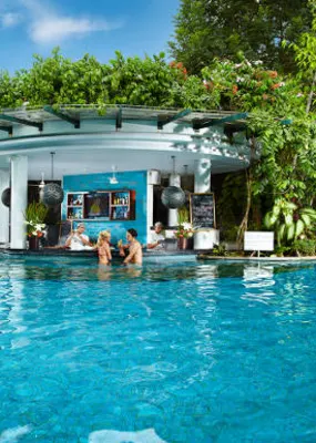 Couple enjoying the sunken bar in the pool in Padma Resort