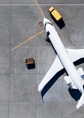 aerial view of three white airplanes parked at the airport