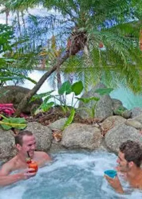 Two gentlemen enjoying jacuzzi in Turtle Cove Beach Resort while having a drink