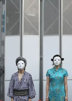 Ten men and women lined up with eight people wearing white masks 
