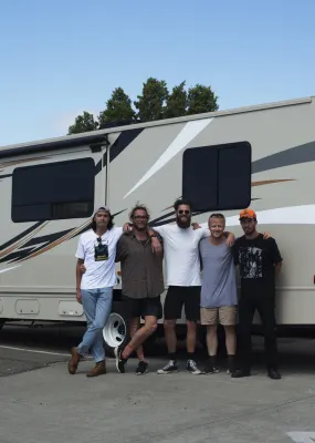 Group of people standing infront of RV