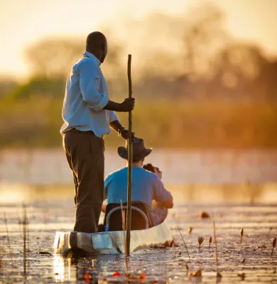 Travelling through the Okavango Delta in a traditional Mokoro on a luxury travel holiday to Botswana.