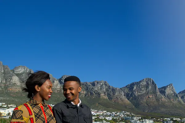 Two people smiling hands at lookout