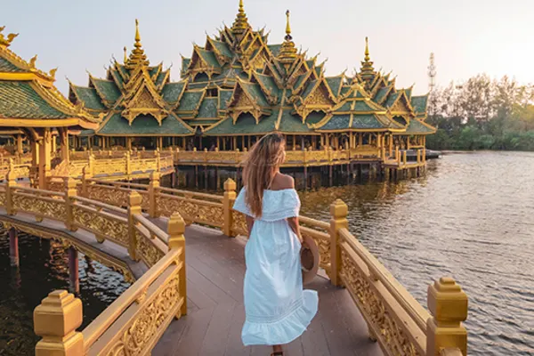 lady walking down path built over water in bangkok