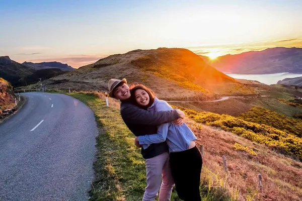 Couple on side of road smiling