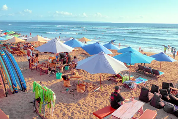 umbrellas and chairs on a beach in canggu