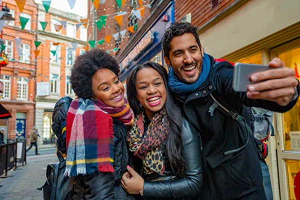 Three people taking a selfie in a street in Ireland