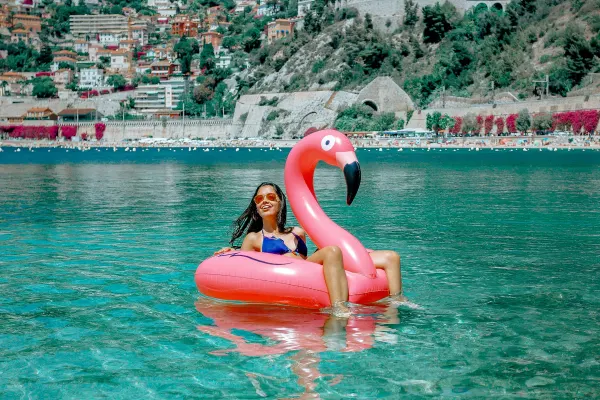 Woman relaxing in a large, inflatable Flamingo
