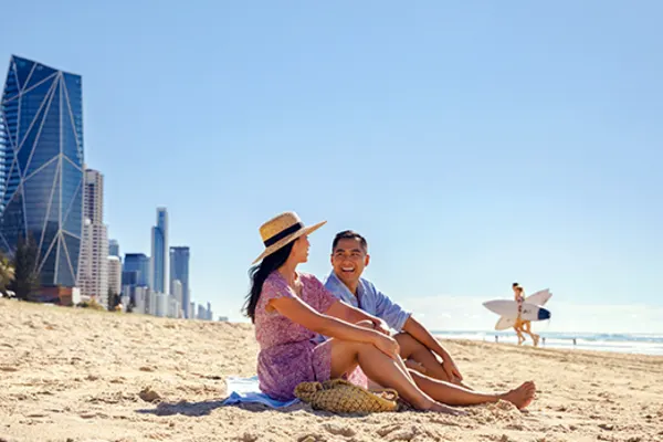 Couple sitting on the beach on the Gold Coast