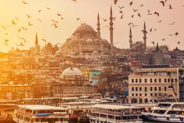 Girl with backpack walking through archway of building in Istanbul