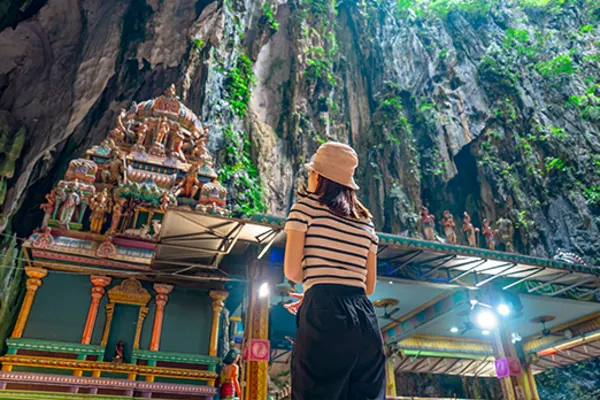 Lady looking up at temple in cave Kuala Lumpur
