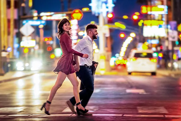 couple walking across busy road in las vegas