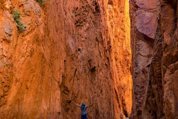Standing between red rocks in the NT