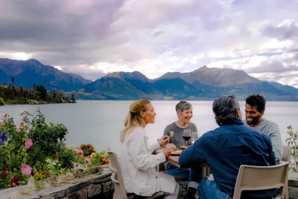 Group of friends sitting by the lake