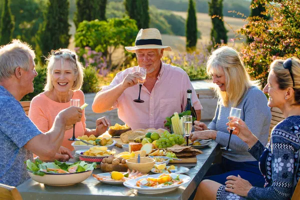 Elderly people having brunch and drinking champagne