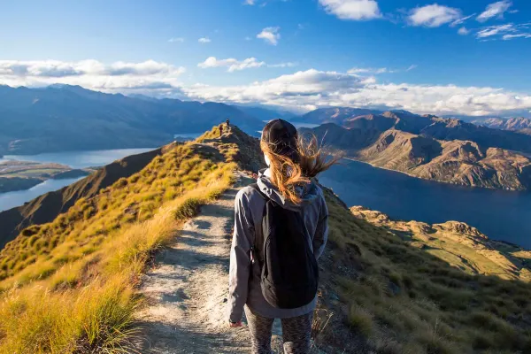 A lady hiking through the New Zealand countryside