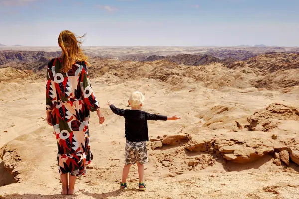 Mother and son looking out at a craggy desert in Namibia
