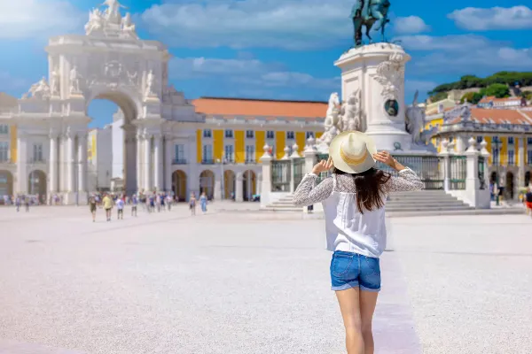 Woman posing in front of Praça do Comércio Plaza in Portugal