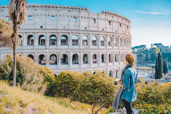 Woman taking a photo of the Colosseum