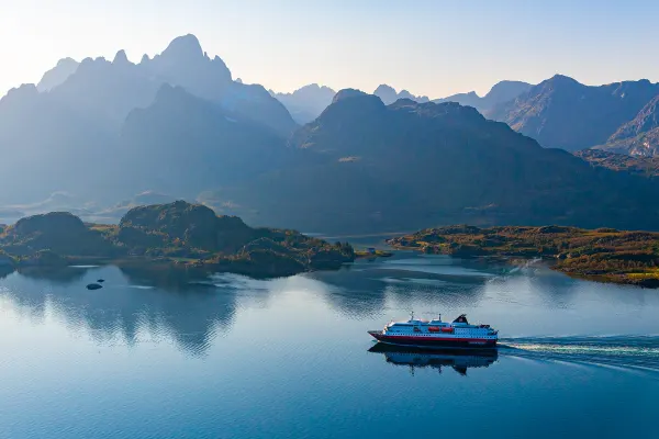 Cruise ship travelling through mountain ranges