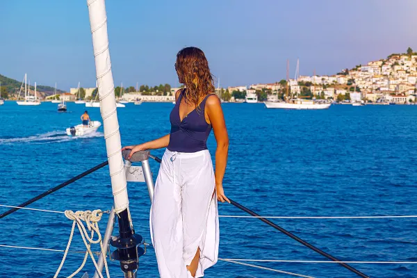 Woman standing on a sailing boat looking out at the horizon