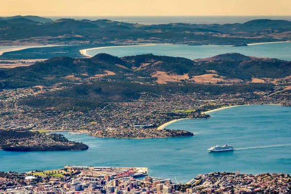 Drone shot of a cruise ship and mountain ranges