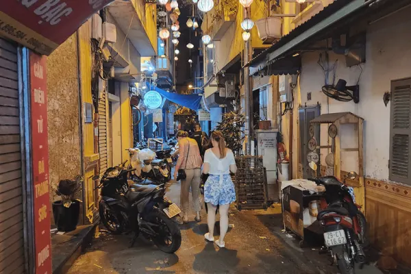 Side street in Vietnam at night lined with motorbikes