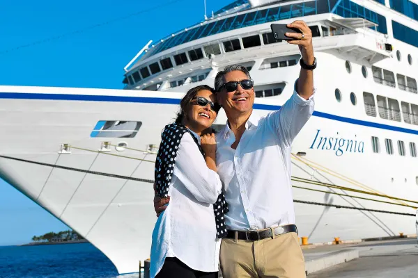 Couple posing in front of docked ship