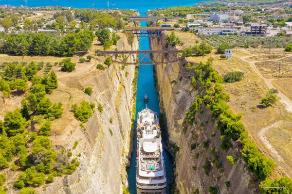 Cruise ship travelling through the middle of two rock faces