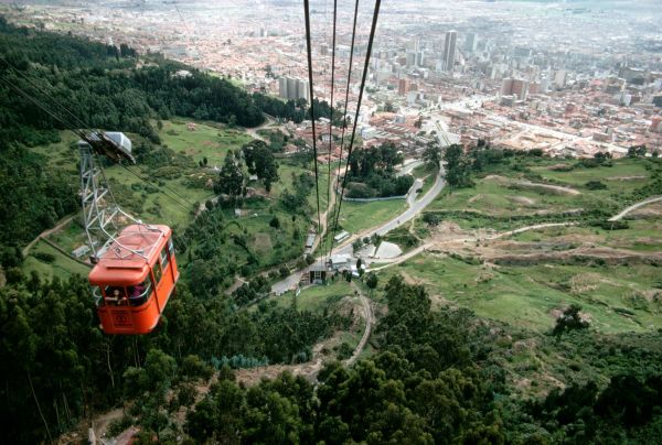 Aerial trams carry visitors up a hill and its park in central Bogota