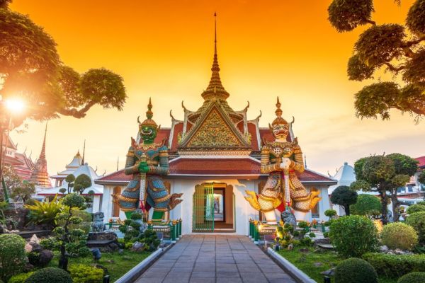 Bangkok temple with a orange and yellow sky in background