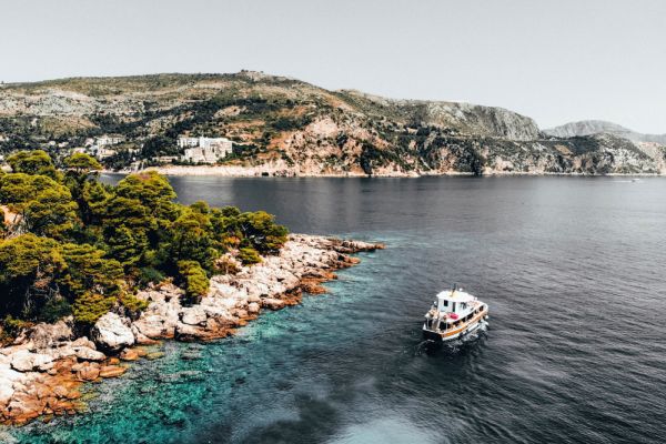 Boat sailing past shoreline
