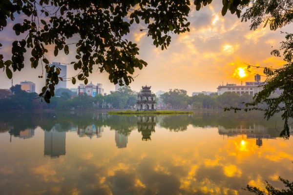 Temple in middle of lake with the sunsetting behind