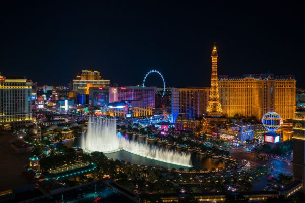 Las Vegas Strip lite up at night with water blasting up from fountain