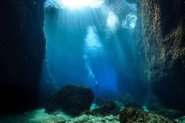 Underwater cave with scuba diver