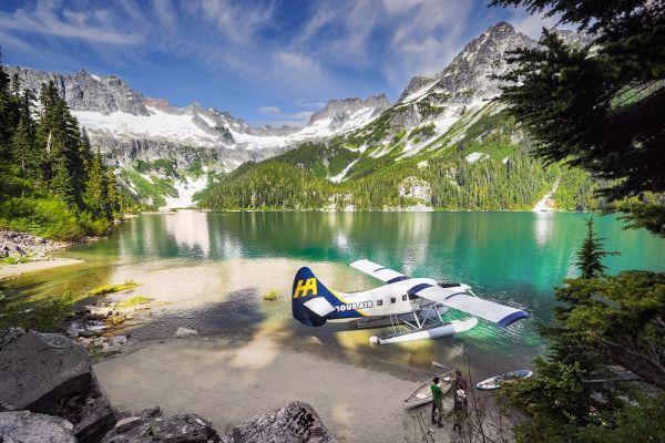 Waterplane on shoreline with snowy mountain top in background