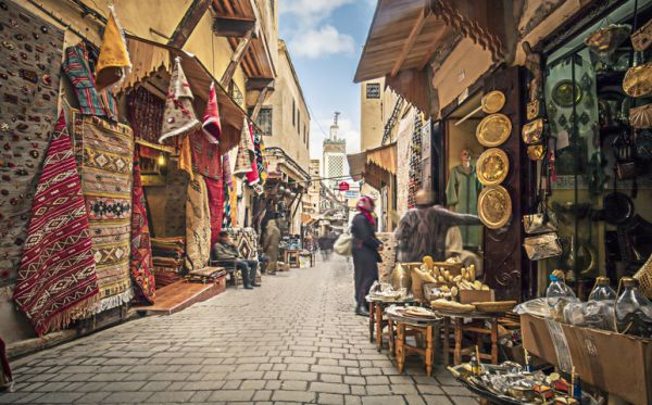 Khan el-Khalili street market, rugs and souvenir's hanging for people to view