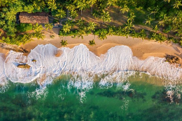 Aerial view of waves crashing onto a beach in Sri Lanka
