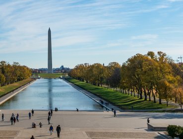 Wide shot of Washington Monument with people looking from a far