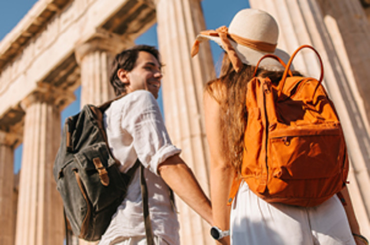couple holding hands in ancient ruins smiling in athens