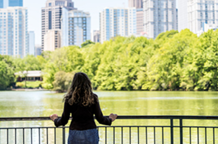 lady in atlanta overlooking water and city