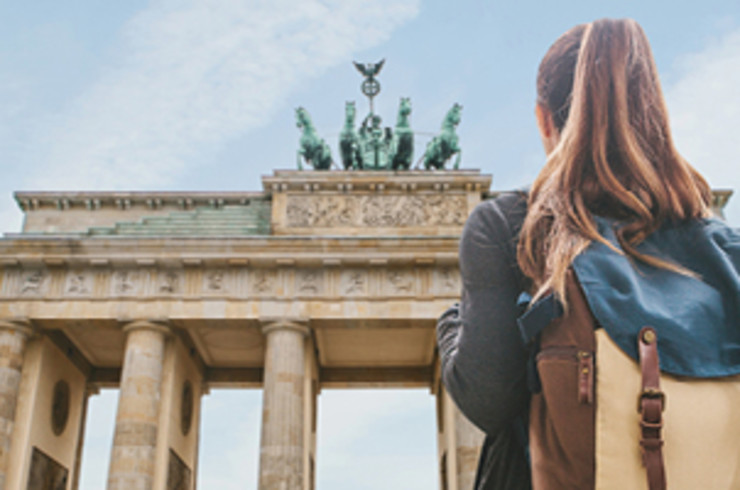 lady with backpack standing outside building in berlin