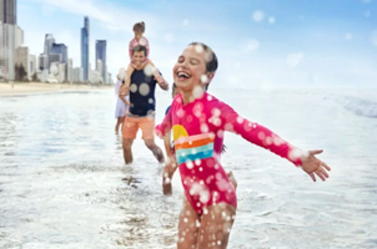 Child splashing in the water at the beach