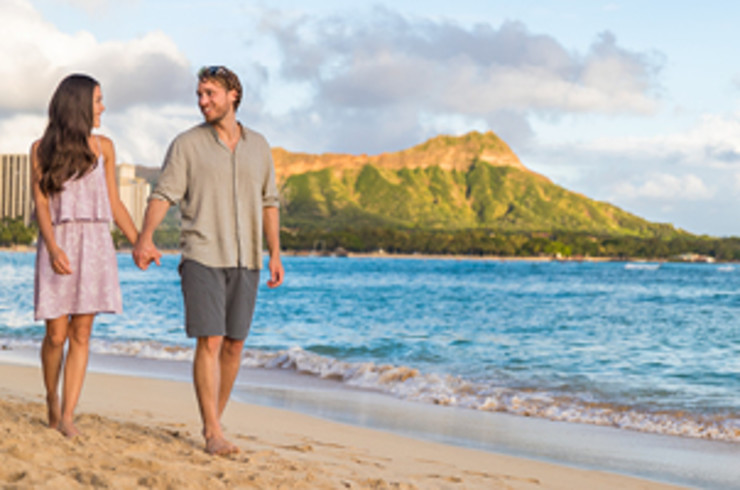 Couple walking along Waikiki beach